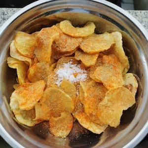 season the potato chips with salt, cumin, and Sichuan chili powder