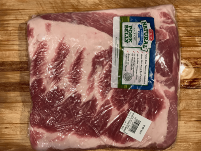 A slab of half-cut pork belly from a Texas grocery