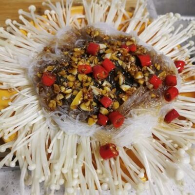 Top the enoki mushrooms with the vermicelli, and pour the sauce over the bean threads