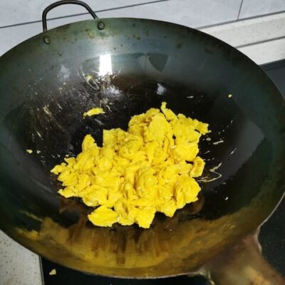 Scramble the eggs and set aside