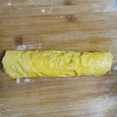 roll the egg and pork filling into a log