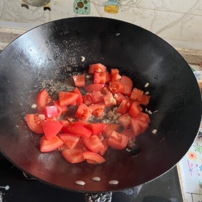 add the garlic and tomatoes