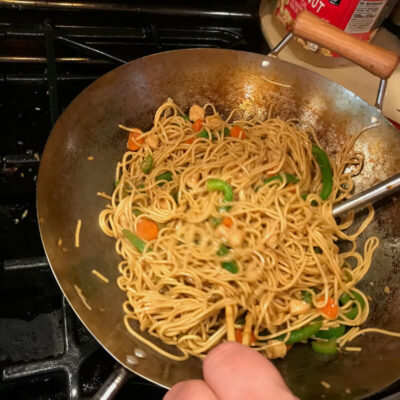 Toss the noodles with a pair of chopsticks