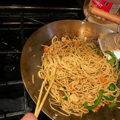 Use chop sticks to stir-fry noodles