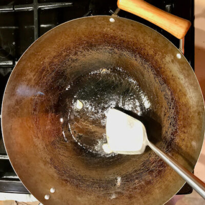 Press the ginger against the pan, then remove the ginger and discard.
