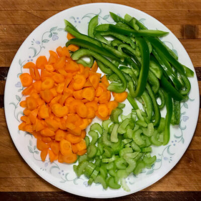 Julienne the green pepper, slice the carrot and celery into thin slices