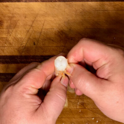 Peel the shrimp by grasping the feet and unwrapping the shell.