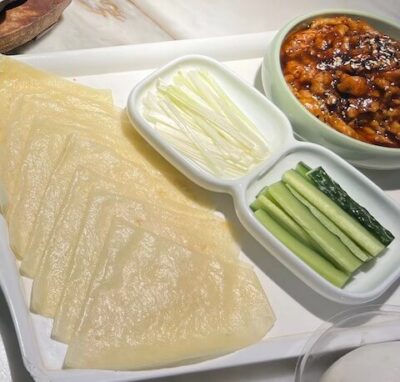 Shredded Pork in Beijing Sauce, also called Peking Shredded Pork, is served with cucumbers and green onions, wrapped in moo shu style pancakes, like Peking Duck. It is a very popular northern Chinese recipe.