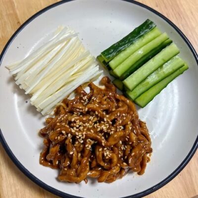 Shredded Pork in Beijing Sauce, also called Peking Shredded Pork, is served with cucumbers and green onions, wrapped in moo shu style pancakes, like Peking Duck. It is a very popular northern Chinese recipe.