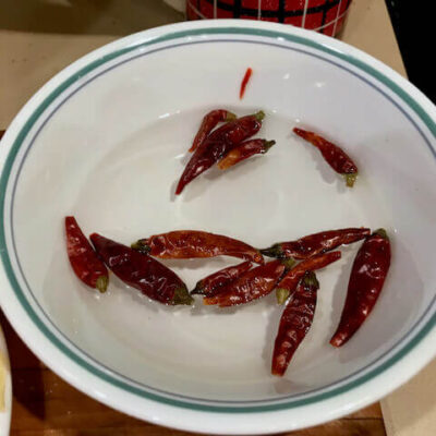 Soak dried chili peppers in warm water for 20 minutes