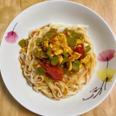 My Mom's Homemade Noodles: (Qīngjiāo fānqié jīdàn miàn) Green Pepper, Tomato, and Egg Noodles.