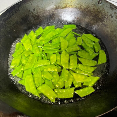 Blanch the snow peas.