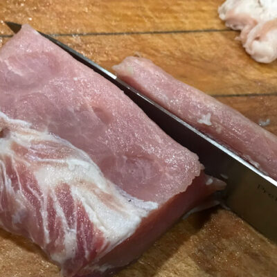 Slice the pork with the grain, about three-eighths of an inch thick (9 to 10 mm)