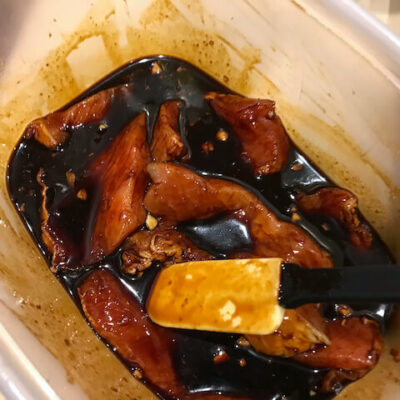 Stir the pork slices in the marinade for even coverage.