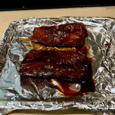 Place the pork, with some marinade, on the foil covered broiler tray.
