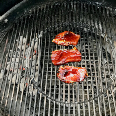 Place the pork on the grill with some marinade on the surface.