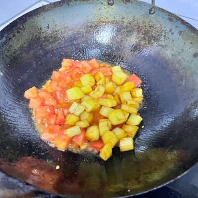 add the potatoes and ketchup or tomato paste, stirring to combine