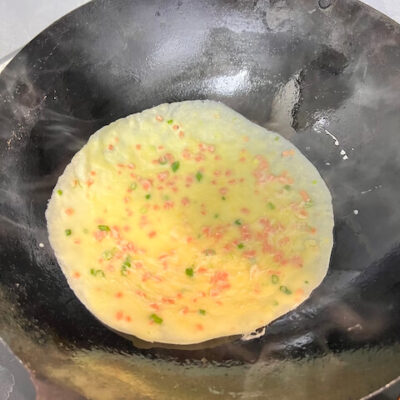 Pour some batter into the pan.