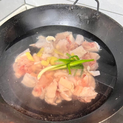 Add the ingredients to the wok and cover with water