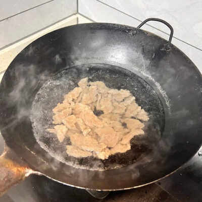 Blanch the beef until it's cooked, showing a little pink at the center