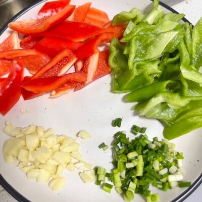 Chop the peppers, garlic, and green onions