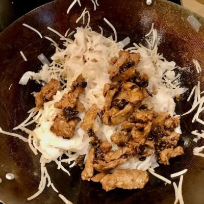 when the mung beans have just begun to wilt, 30 seconds to 1 minute, add the beef and beans back to the wok with the juices and oil from the beef, pour in the sauce, and toss to combine. when the beef is heated through, add the shredded green onion and stir-fry to combine