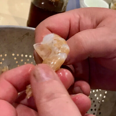 Grasp the flippers and peel around the shrimp to break and remove the shell.