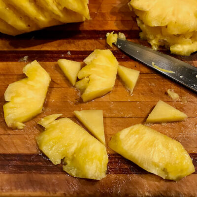 Quarter the pineapple slices, then cut away the core, then chop the slices into bite-sized chunks.