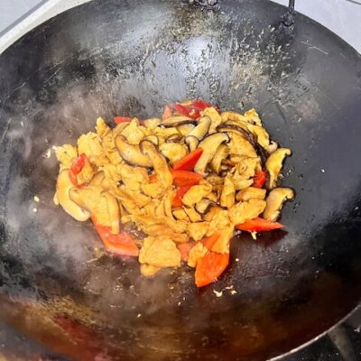 Add the red peppers to the simmering broth