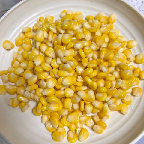 Drain the blanched corn kernels