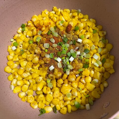 Add the cumin, ground chilies, and green onion