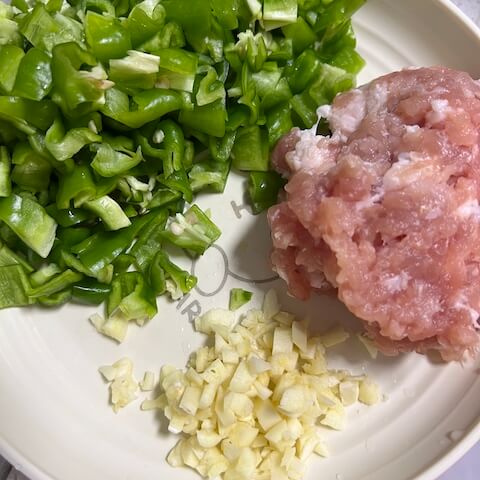 Mince the pork, finely chop the garlic and green peppers