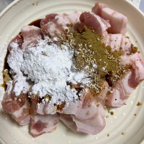 Add all the seasonings (light soy sauce, dark soy sauce, cumin powder, corn starch, cooking wine) and sesame seeds the pork belly